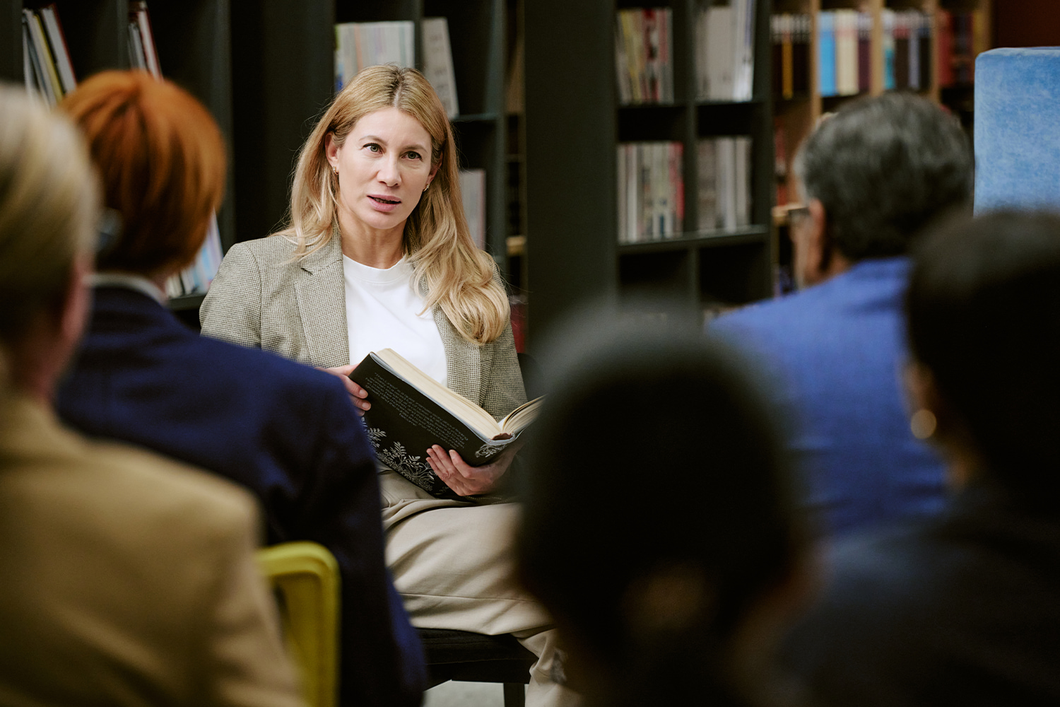 Woman leading a group discussion, highlighting training and education in Utah employment.