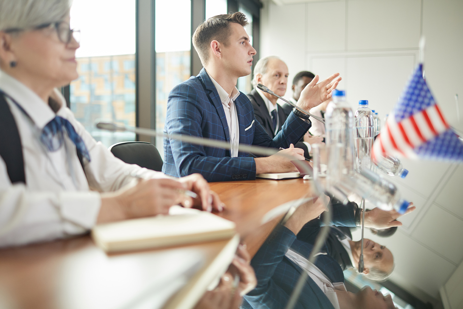 Panel speaking at a table with a US flag, reflecting public sector jobs with the biggest employers in Utah.