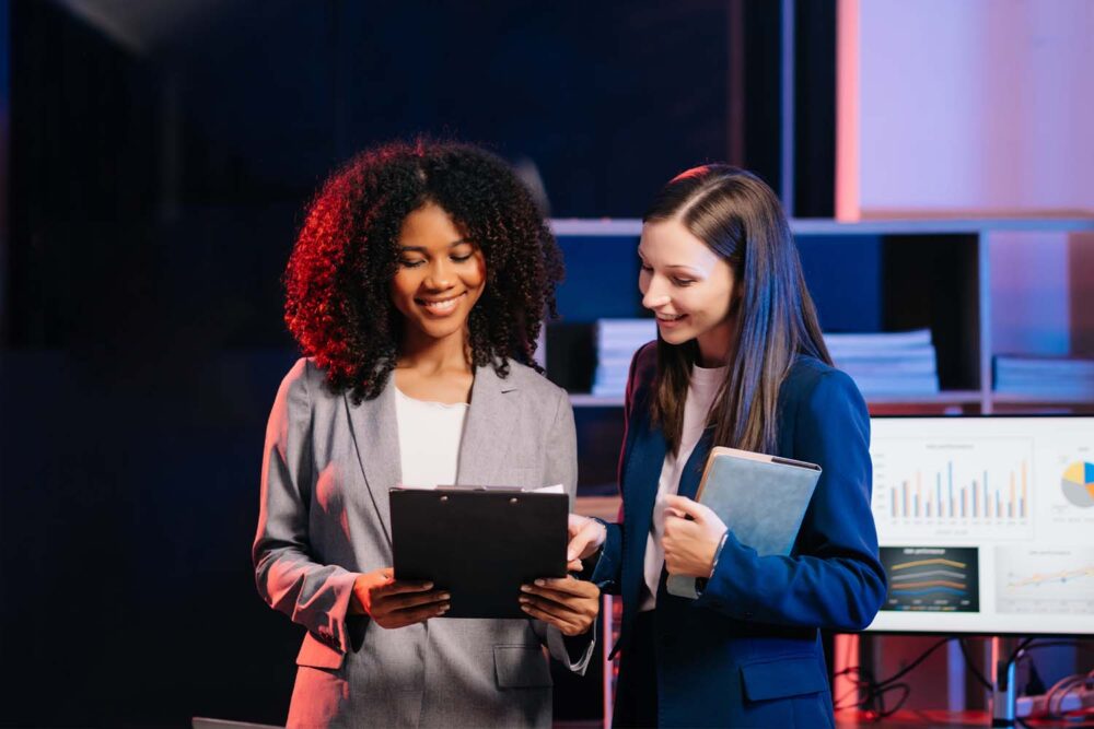 Colleagues discussing women in tech stats and workplace challenges. Essential for building a supportive women tech network.