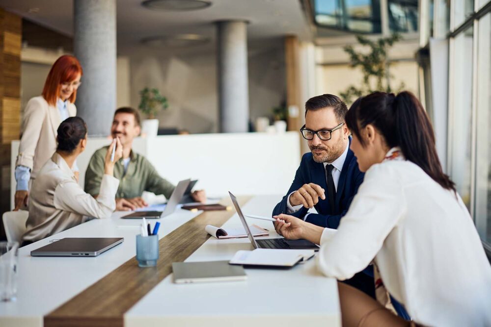 Colleagues collaborating on financial models using fp&a tools. Shows the day-to-day application of financial planning and analysis skills.