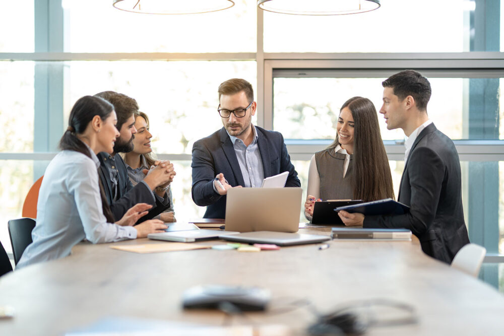 A diverse finance team discussing financial planning and analysis strategy during a meeting. Essential for evaluating collaborative fp&a skills.
