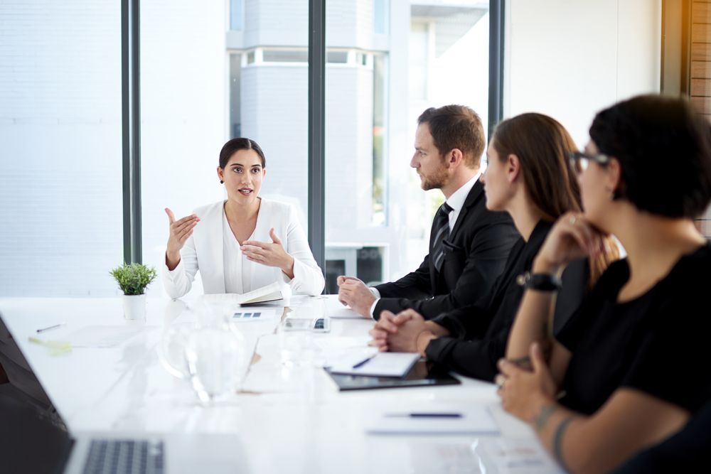 A woman leading a boardroom meeting on gender diversity in tech. Highlighting leadership and empowerment for women in technology.