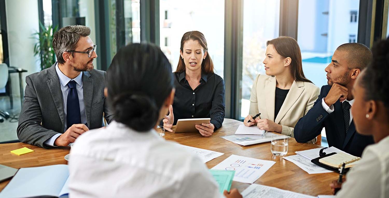 Leadership team discussing fp&a recruitment and talent acquisition strategies for a growing financial planning and analysis department.