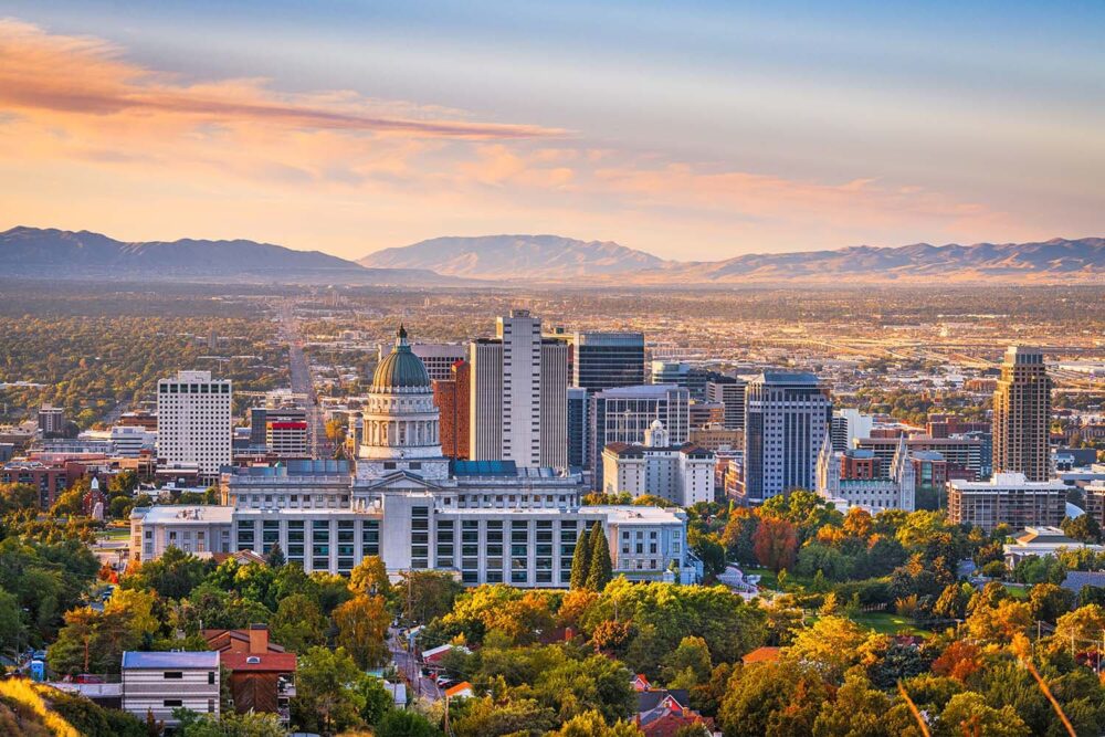 Utah city skyline at sunset. Top life science recruitment agencies analyze regional biotech hubs to source elite executive-level talent.