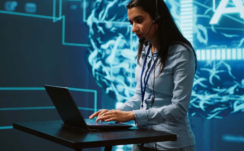 Recruiter wearing a headset and typing on a laptop in front of a glowing AI network graphic, symbolizing AI for recruiters at work