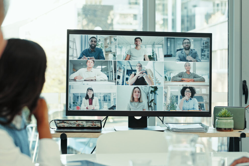 Recruiter conducting a virtual panel interview with nine candidates on a video call screen, an example of AI in the hiring process