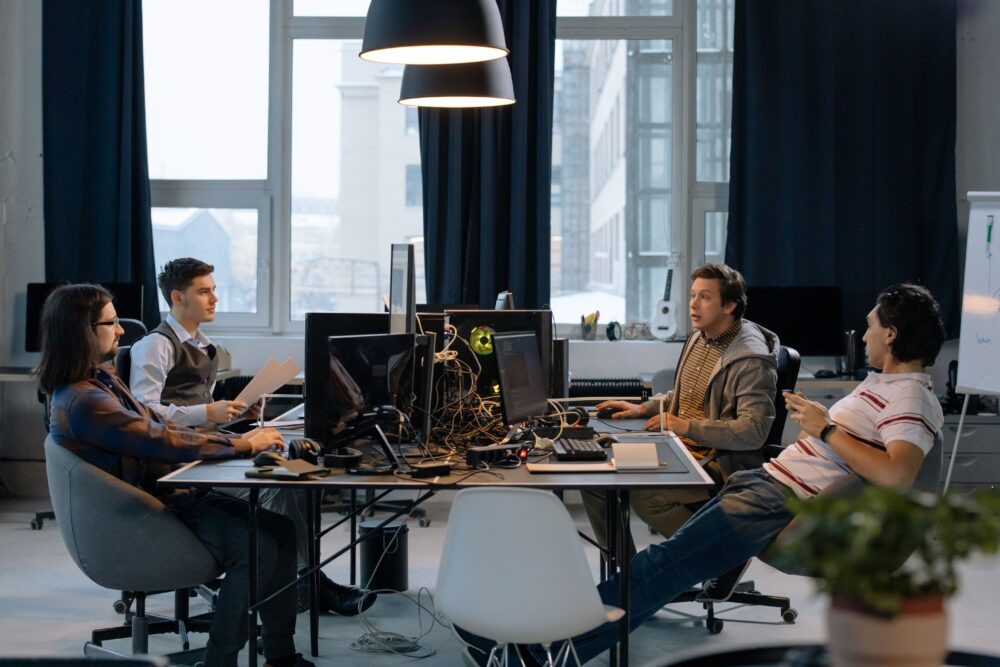 Young professionals collaborating in a vibrant office setting with computers and documents
