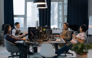 Young professionals collaborating in a vibrant office setting with computers and documents