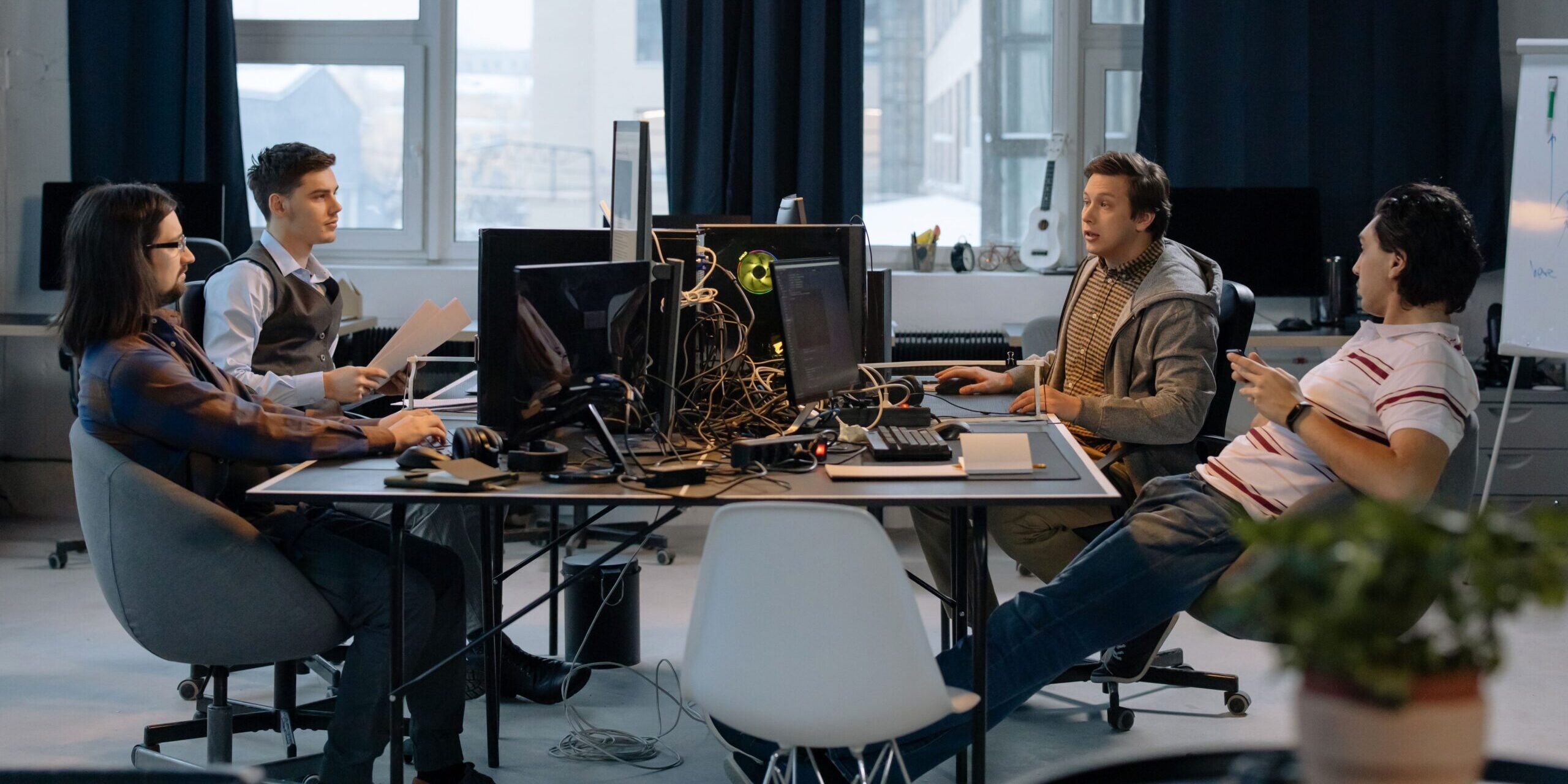 Young professionals collaborating in a vibrant office setting with computers and documents